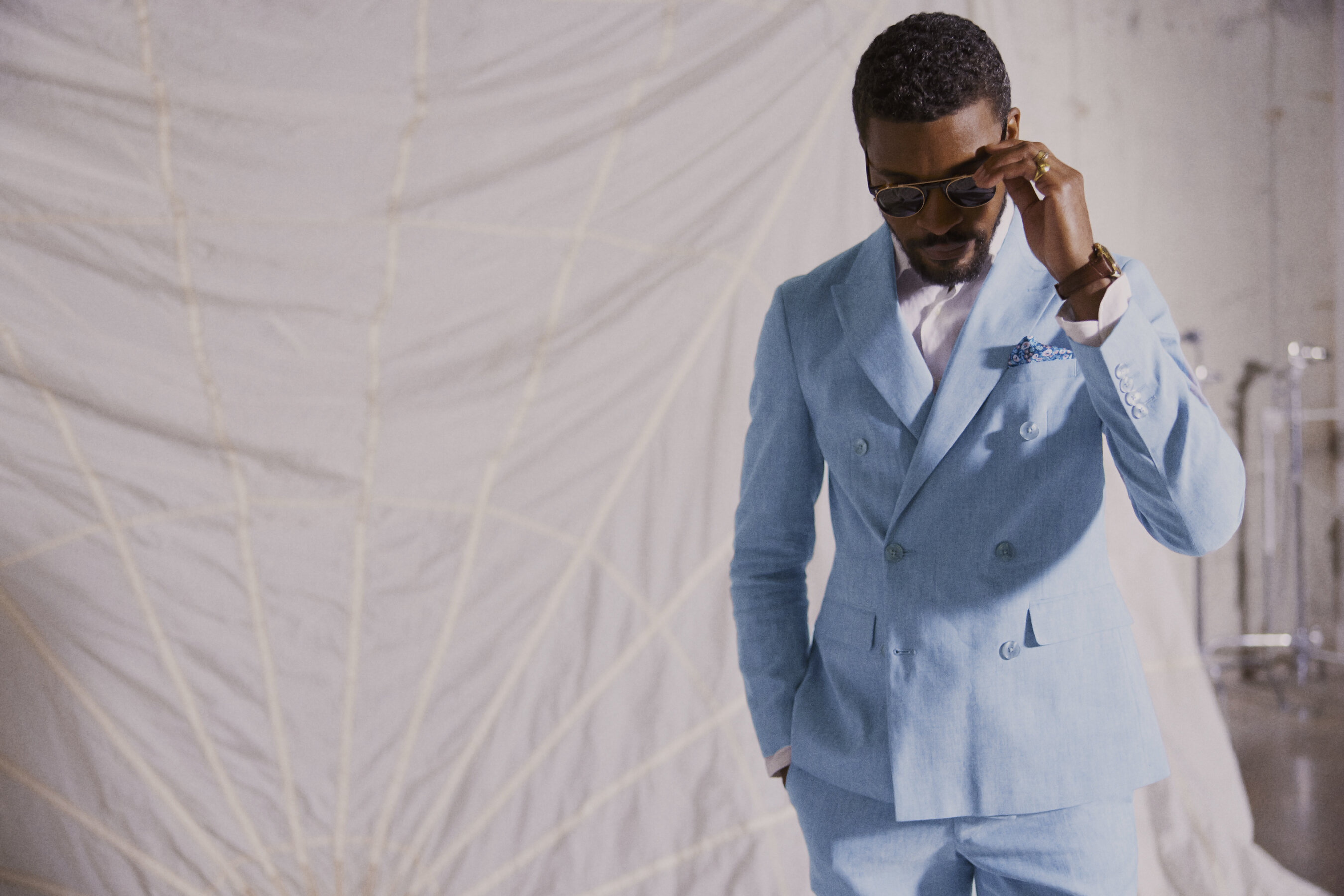 Moss Box launch photograph showing a model in a pale blue double-breasted suit