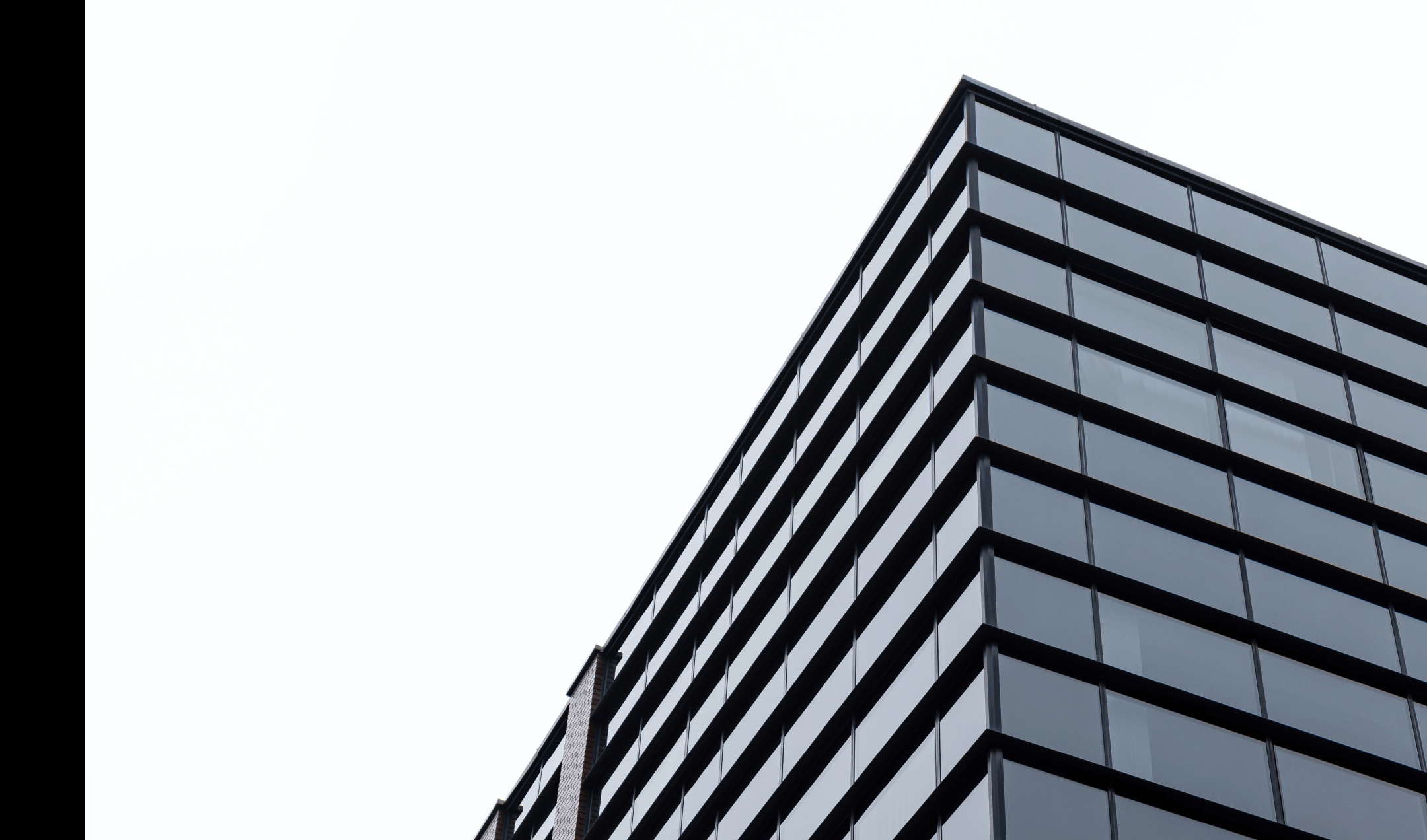An angular commercial building against a bright sky, pictured on Cadre’s website