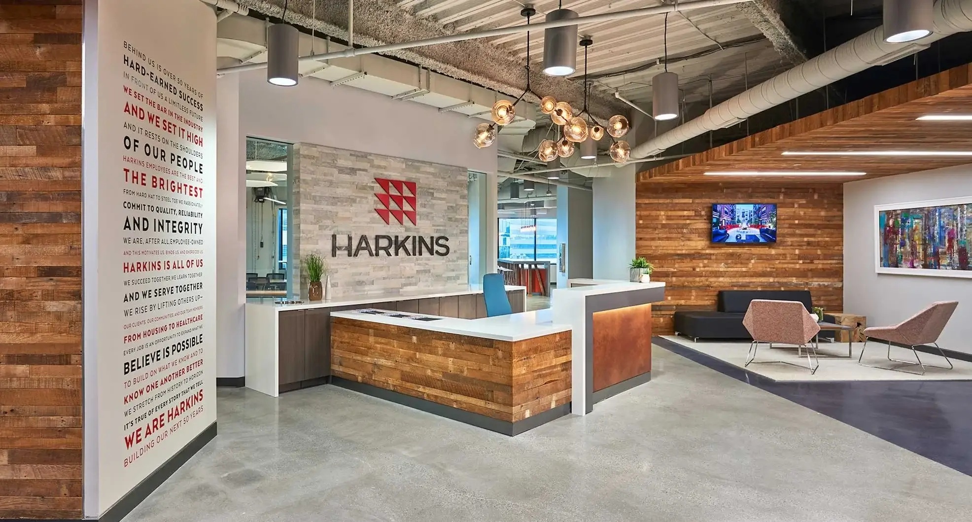 Harkins Builders reception area with wood finishes, seating and company signage