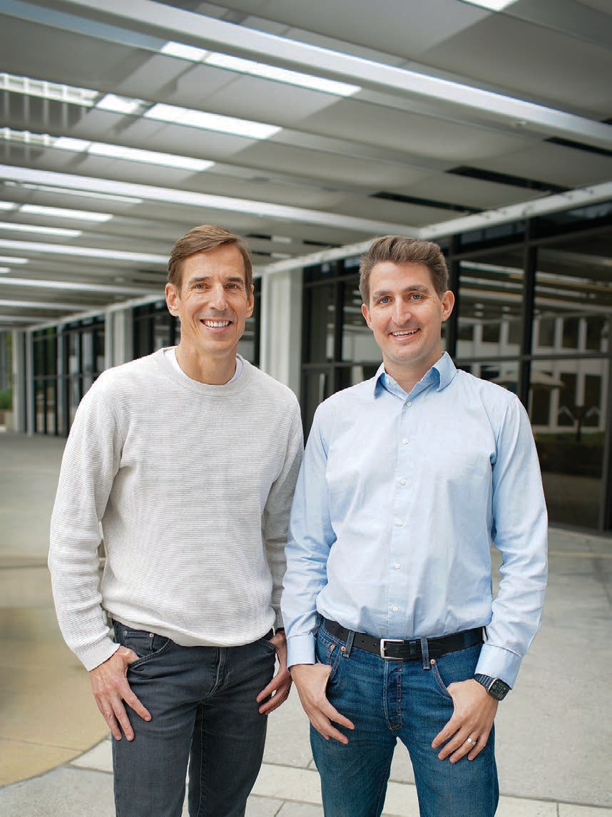 John Keatley and Caleb Morse standing together outside a modern office building