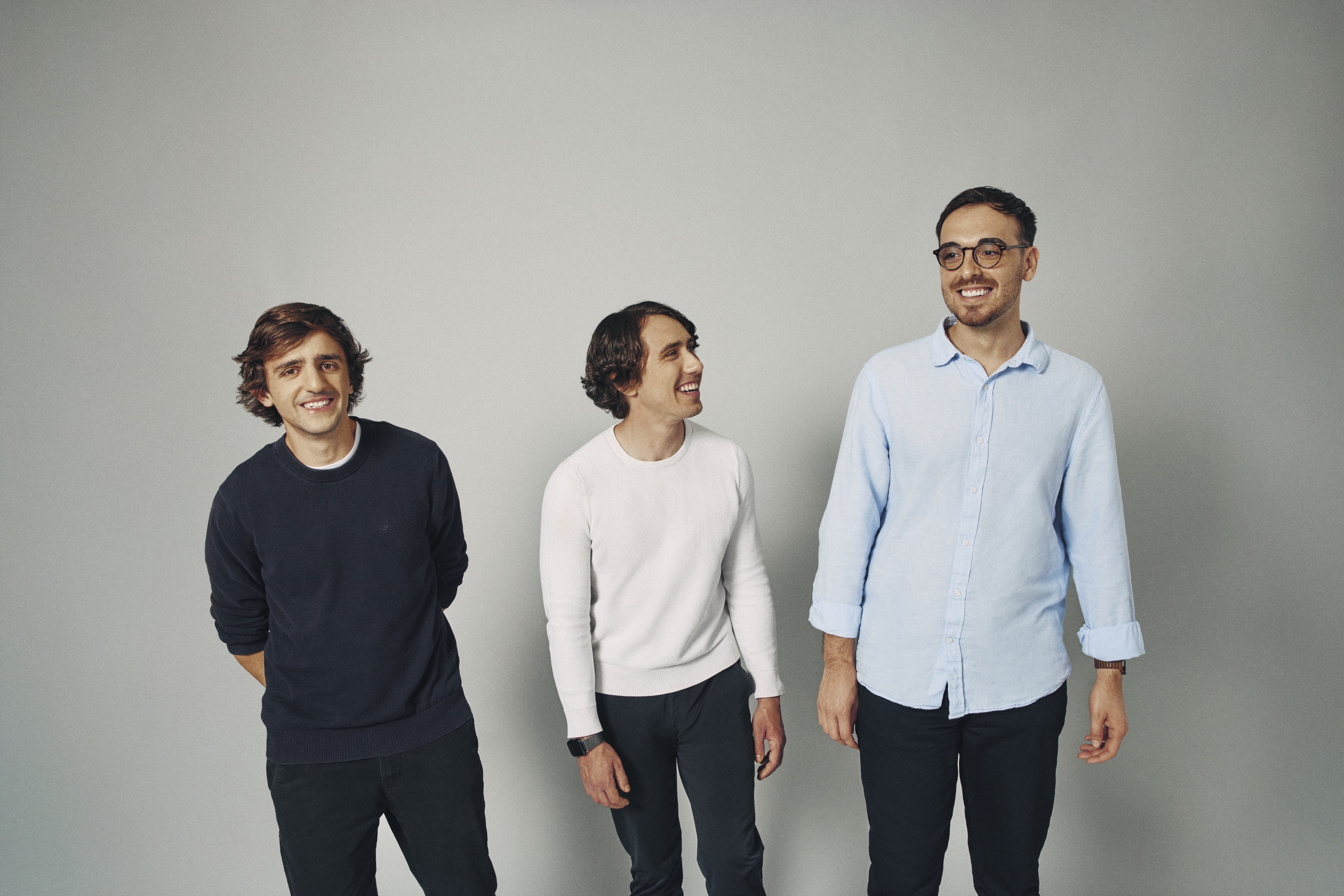 Firecrawl co-founders Nicolas Silberstein Camara, Caleb Peffer and Eric Ciarla standing together