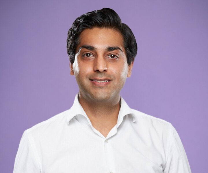 Callsign co-founder Zia Hayat in a white shirt against a violet background