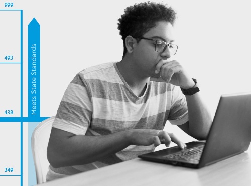 A student concentrating on a laptop in a ClearSight promotional photograph