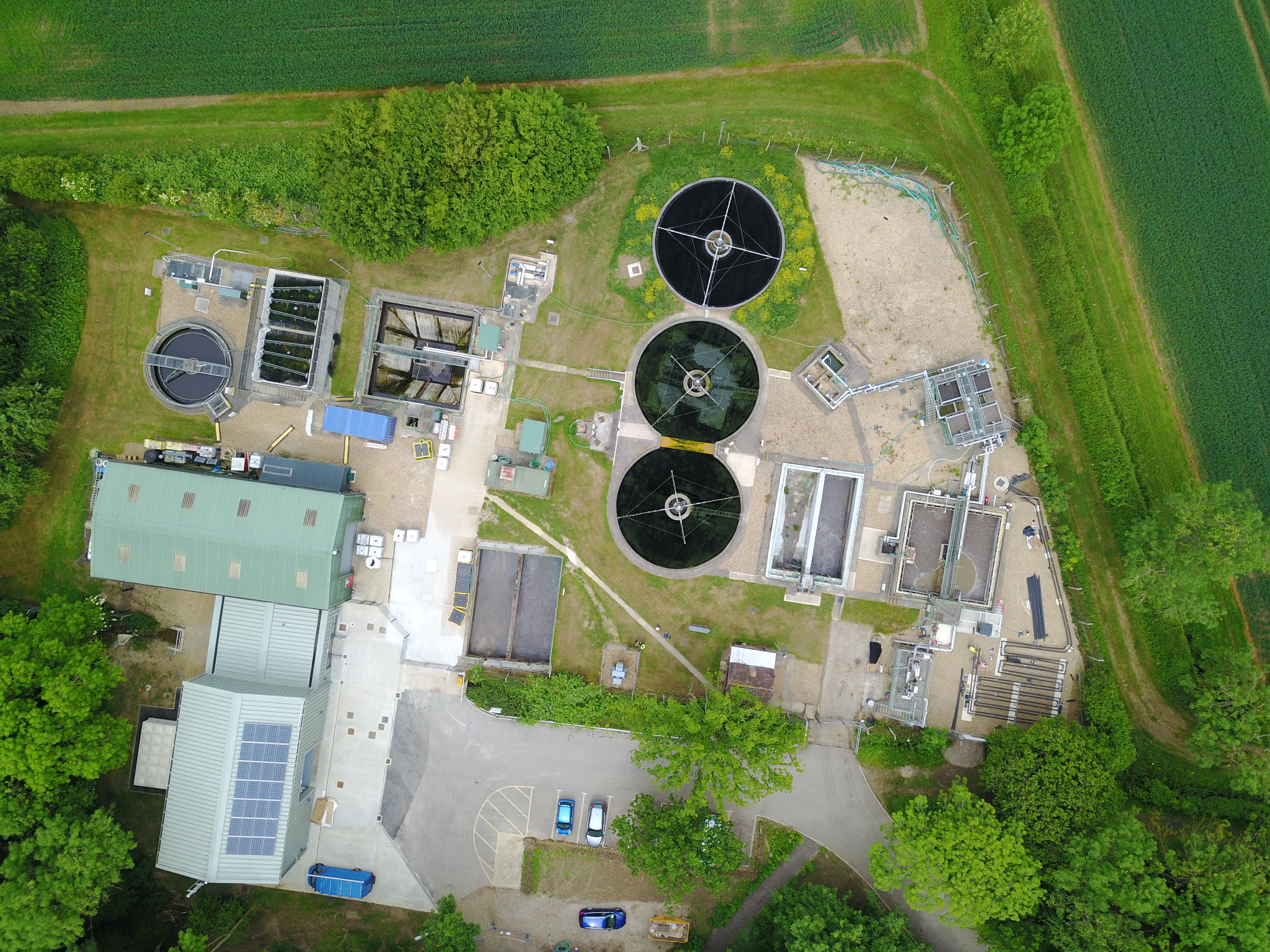 Aerial view of circular treatment tanks and research buildings at Cranfield’s pilot facility