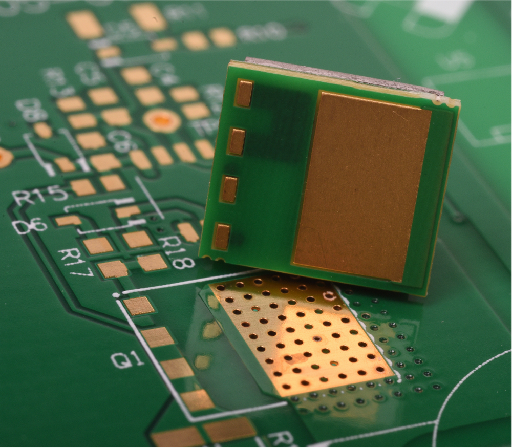 CGD Application Interface Board with gold contacts above a green circuit board