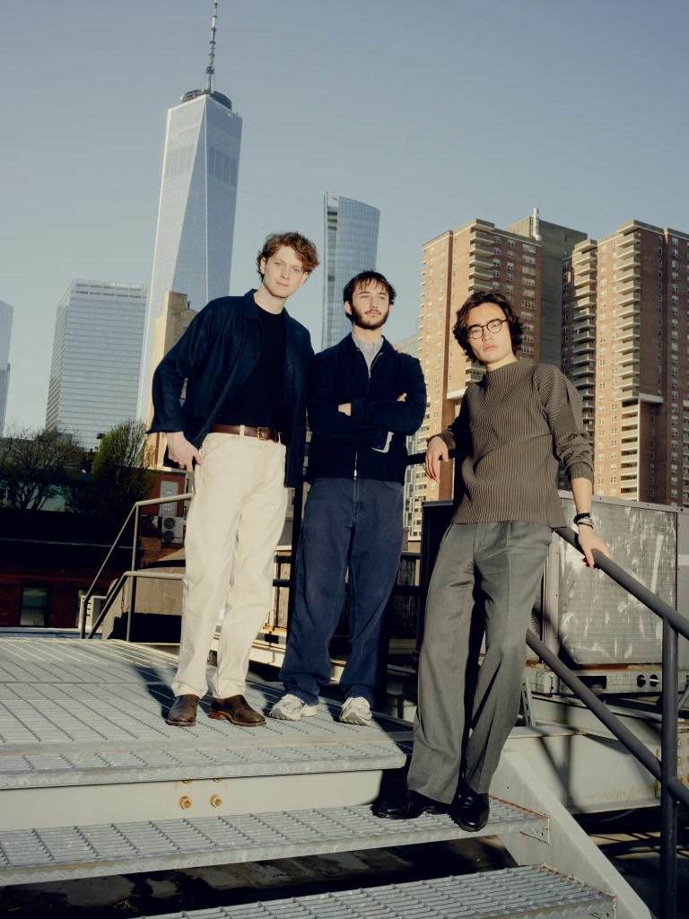 Aaru cofounders Cameron Fink, John Kessler and Ned Koh standing on outdoor steps in New York