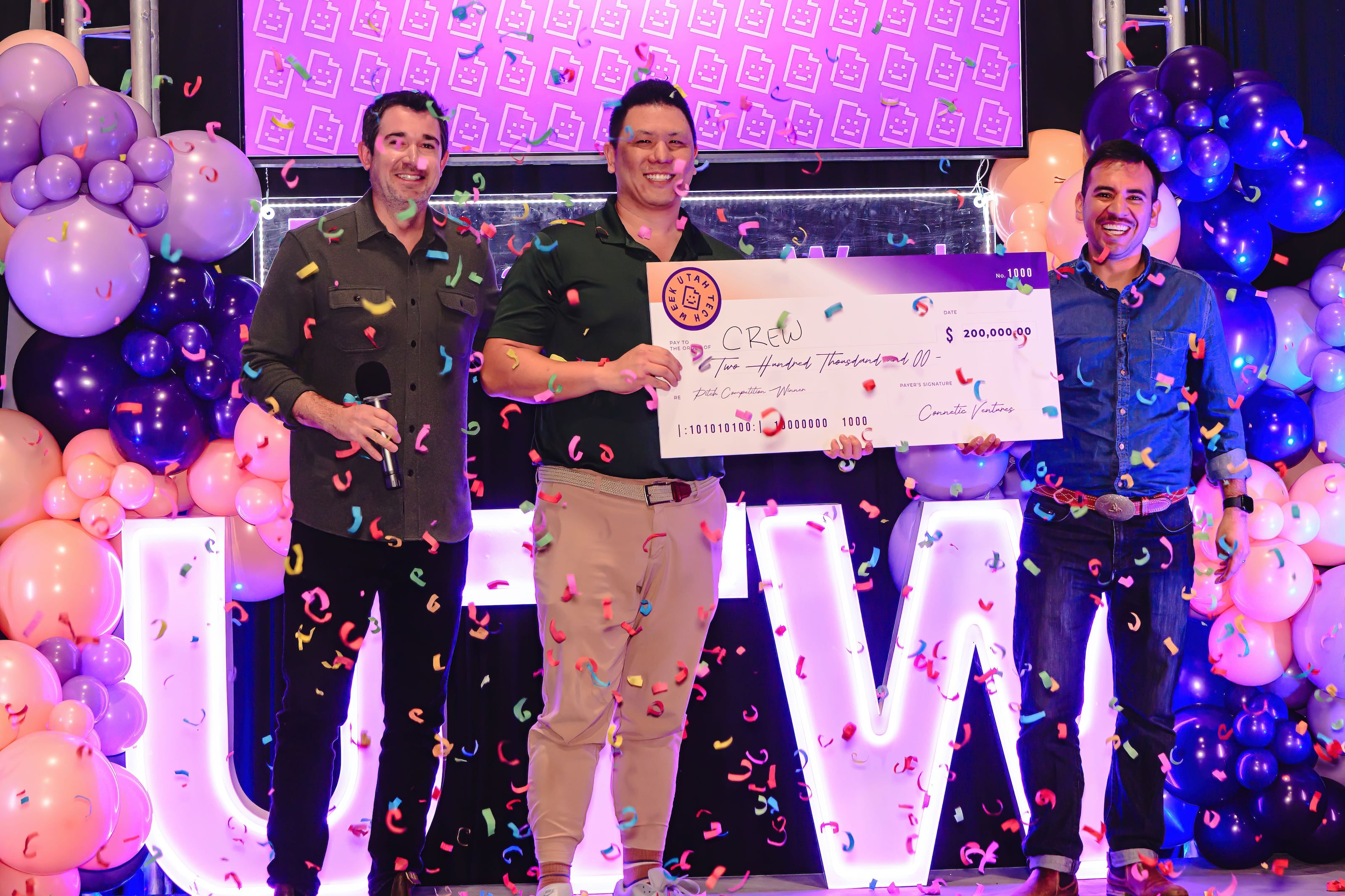 Cameron Lam holds Crew’s $200,000 winning check at Utah Tech Week as confetti falls