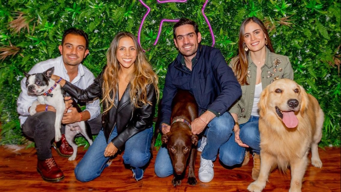 Laika founders Tulio Jiménez, Andrea González, Camilo Sánchez and Manuela Sánchez pose with dogs.