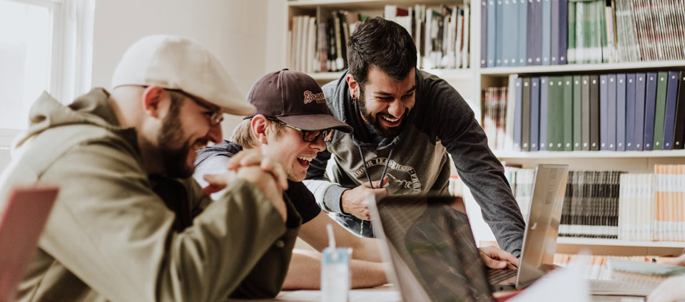 Three people gathered around laptops in a photograph published on Cantina’s safety page