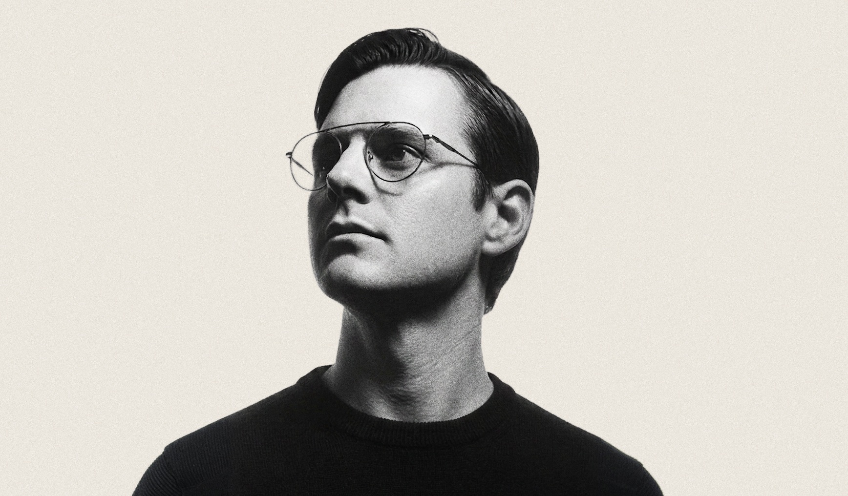 Black-and-white portrait of Cantos founder Ian Rountree wearing glasses