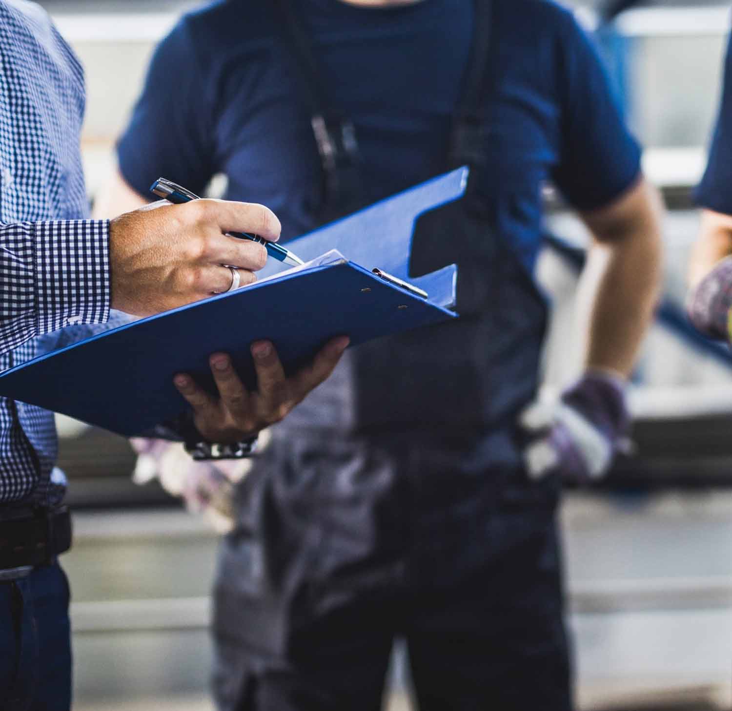 Illustrative team discussion with clipboards, from Capstone’s pay-for-performance page