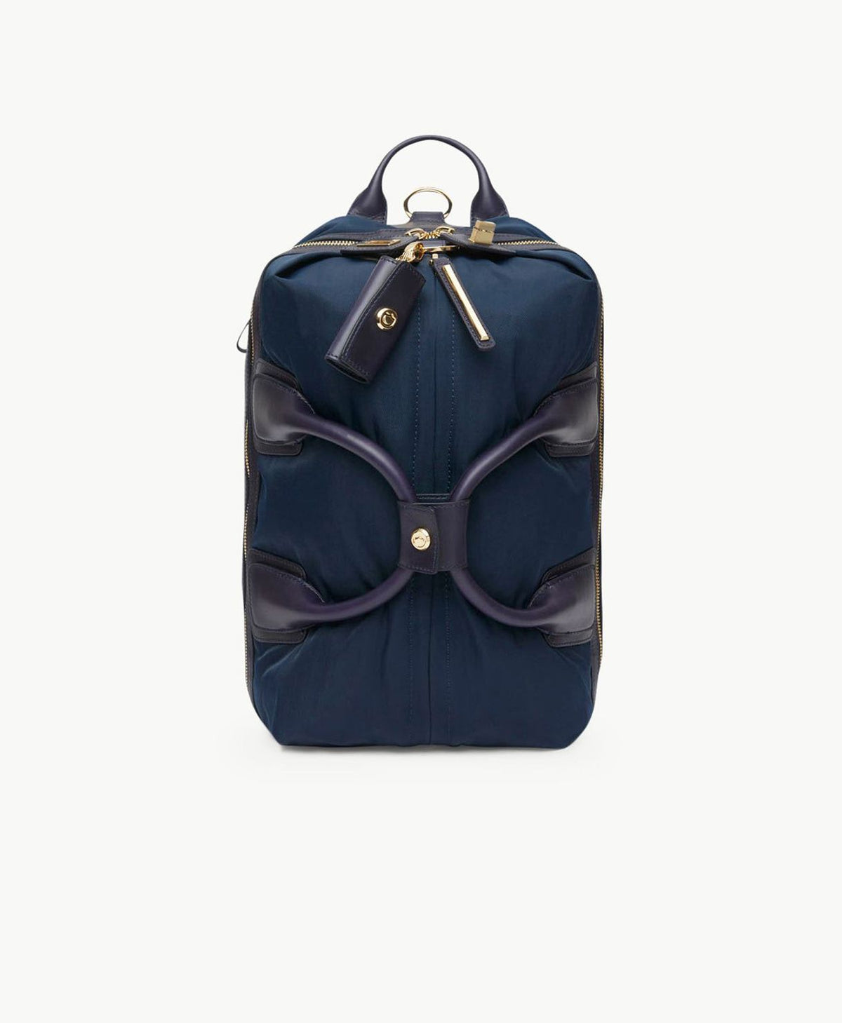 A navy CARAA Studio Bag shown upright with leather handles and gold hardware