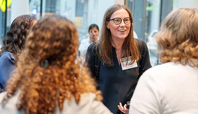 Caralynn Nowinski Collens speaking with attendees at Northwestern's institute launch