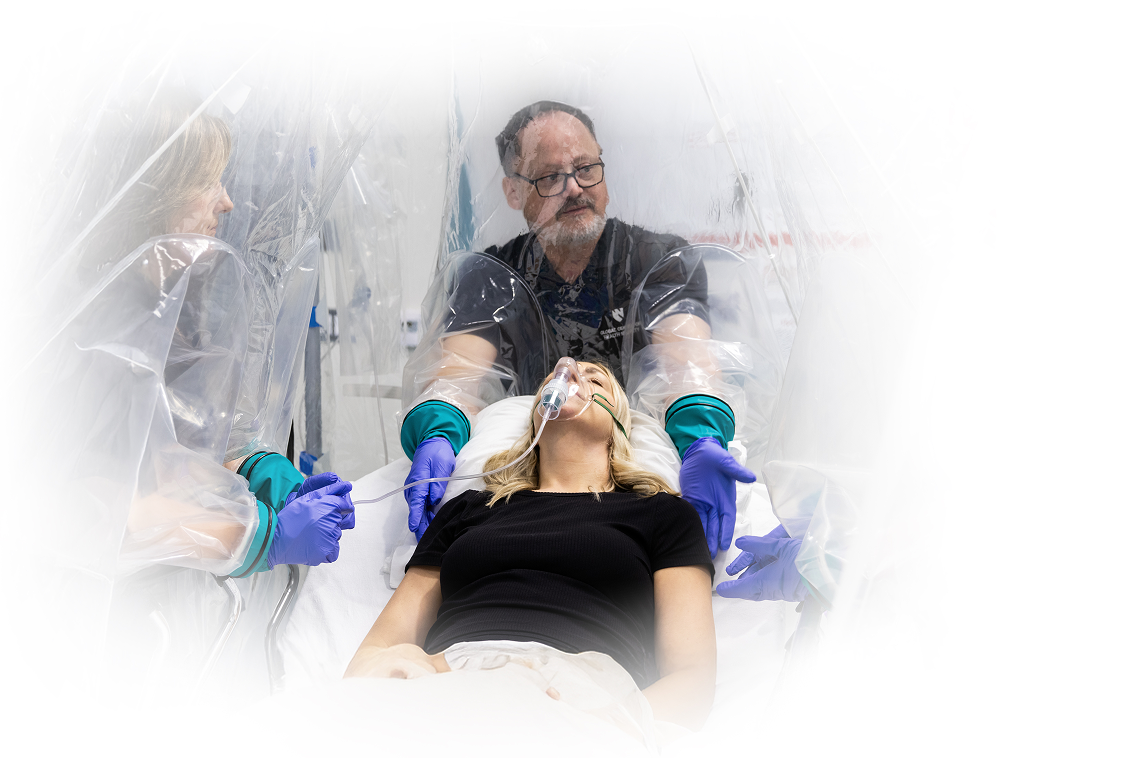 The Carecube negative-pressure isolation canopy in use over a hospital bed