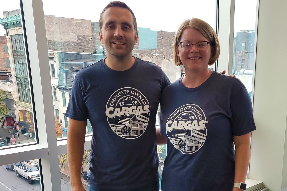 Two Cargas employees wearing shirts celebrating employee ownership since 1998