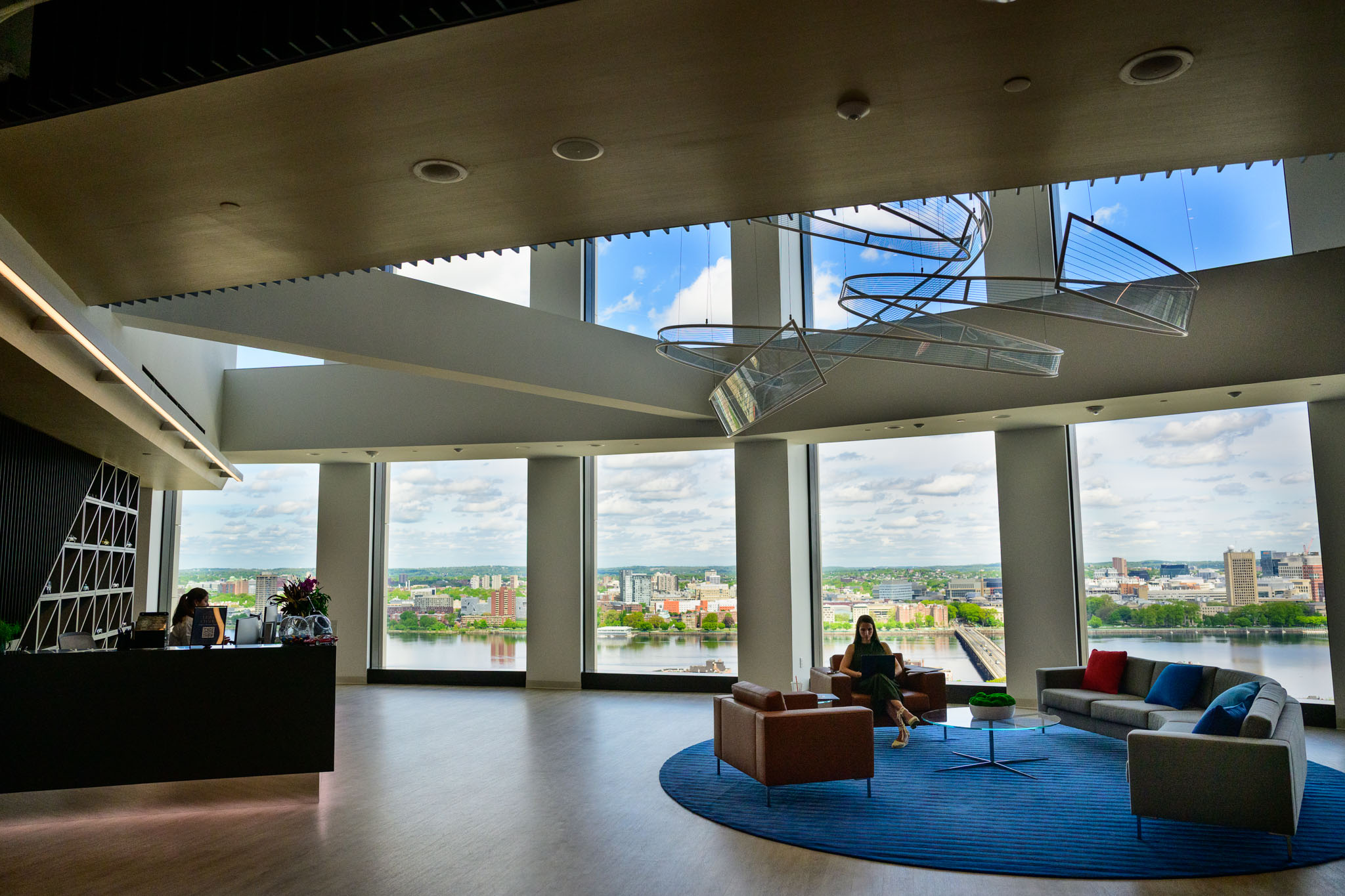 CarGurus Boston office lounge with seating, a coffee bar and large windows overlooking the Charles River
