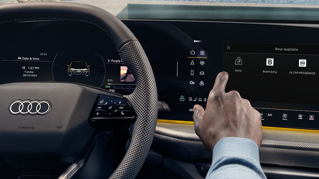 A hand using the CARIAD-powered application store in an Audi dashboard