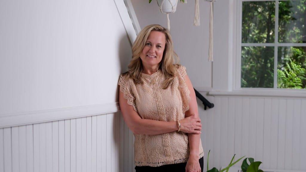 Carol Andersen, CEO of Bloom for Women, seated for an interview