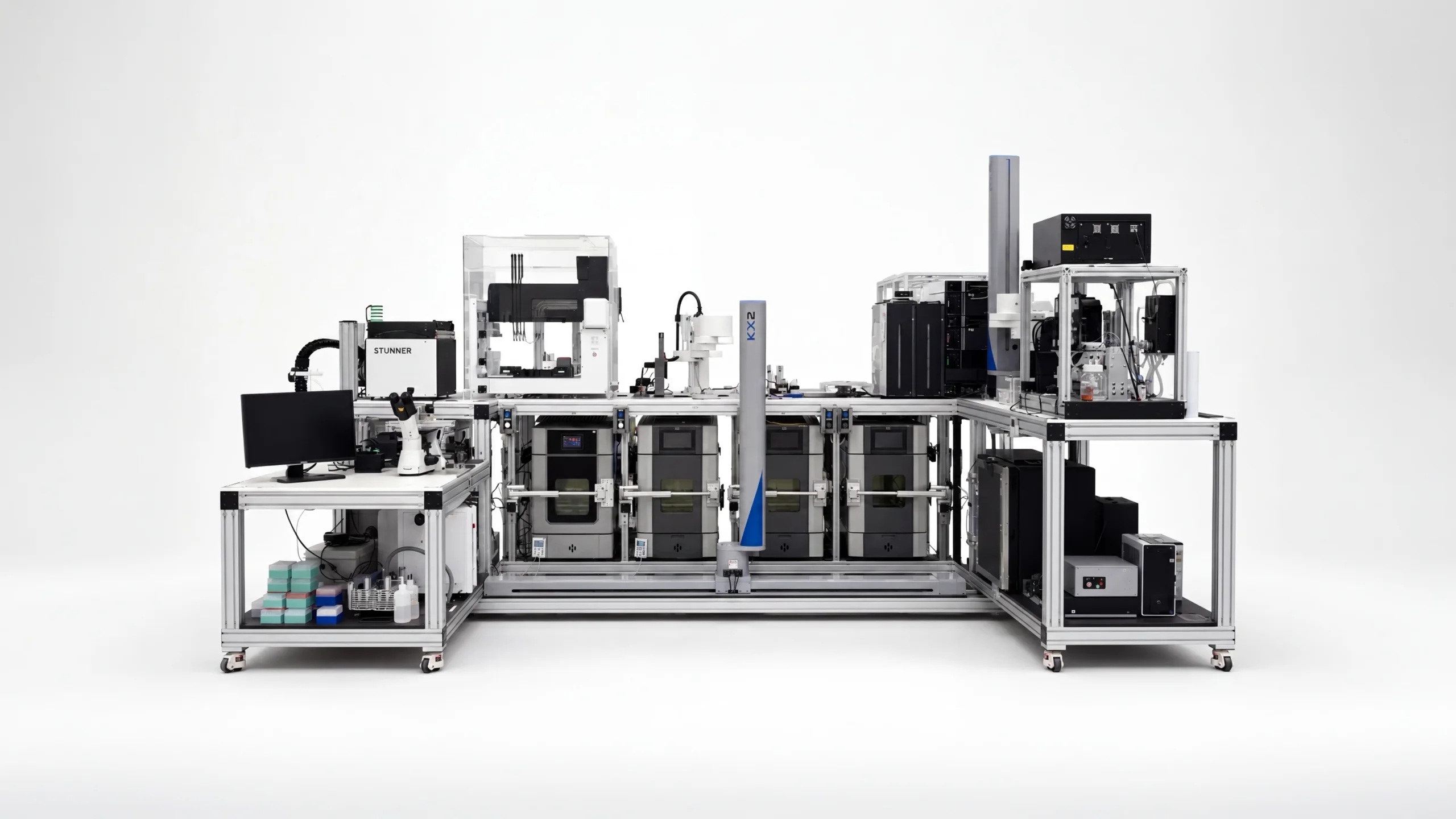 Persist AI’s robotic formulation workcell, with testing equipment arranged around a robotic arm