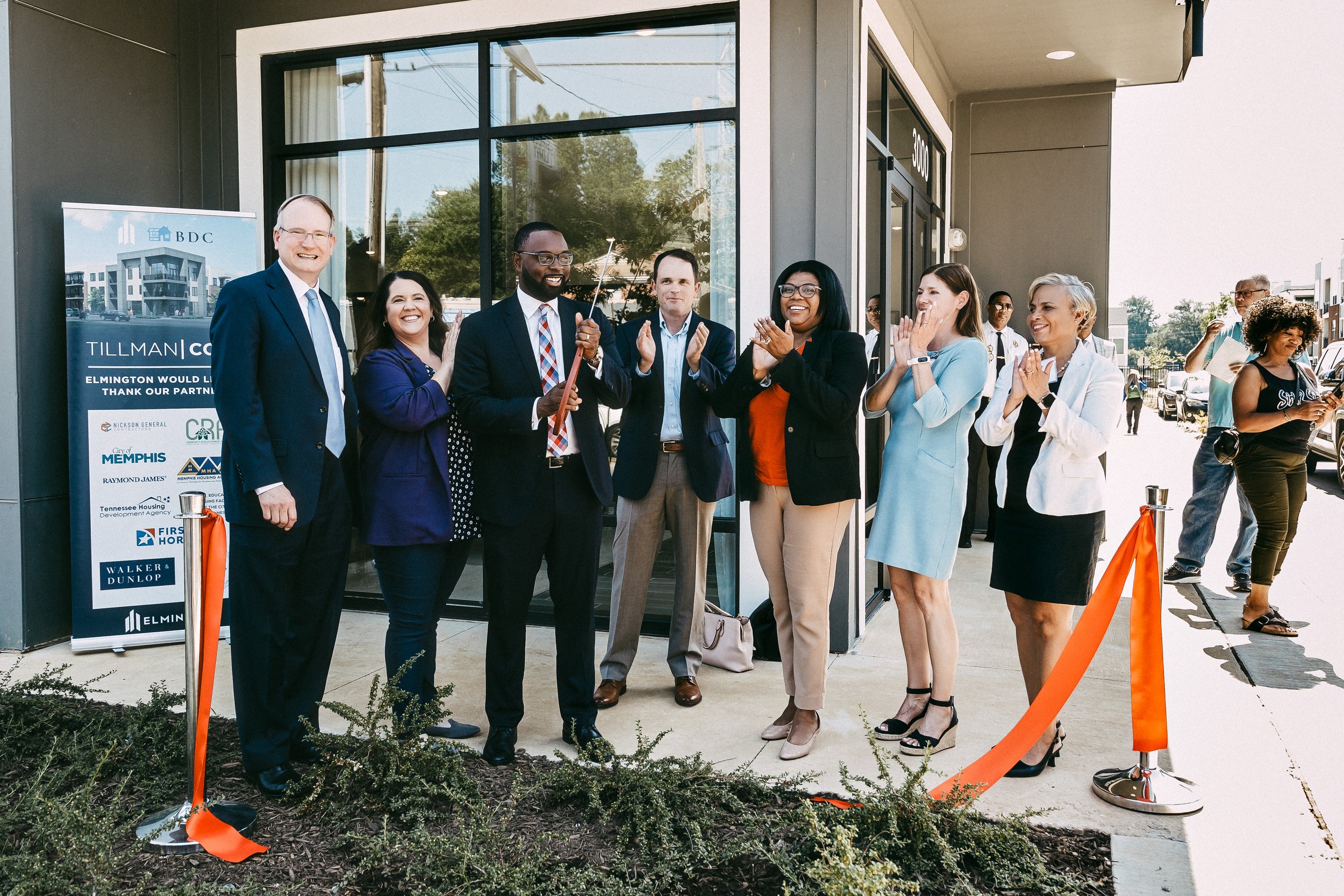 Community leaders and development partners applaud during a ribbon-cutting ceremony at Tillman Cove in Memphis