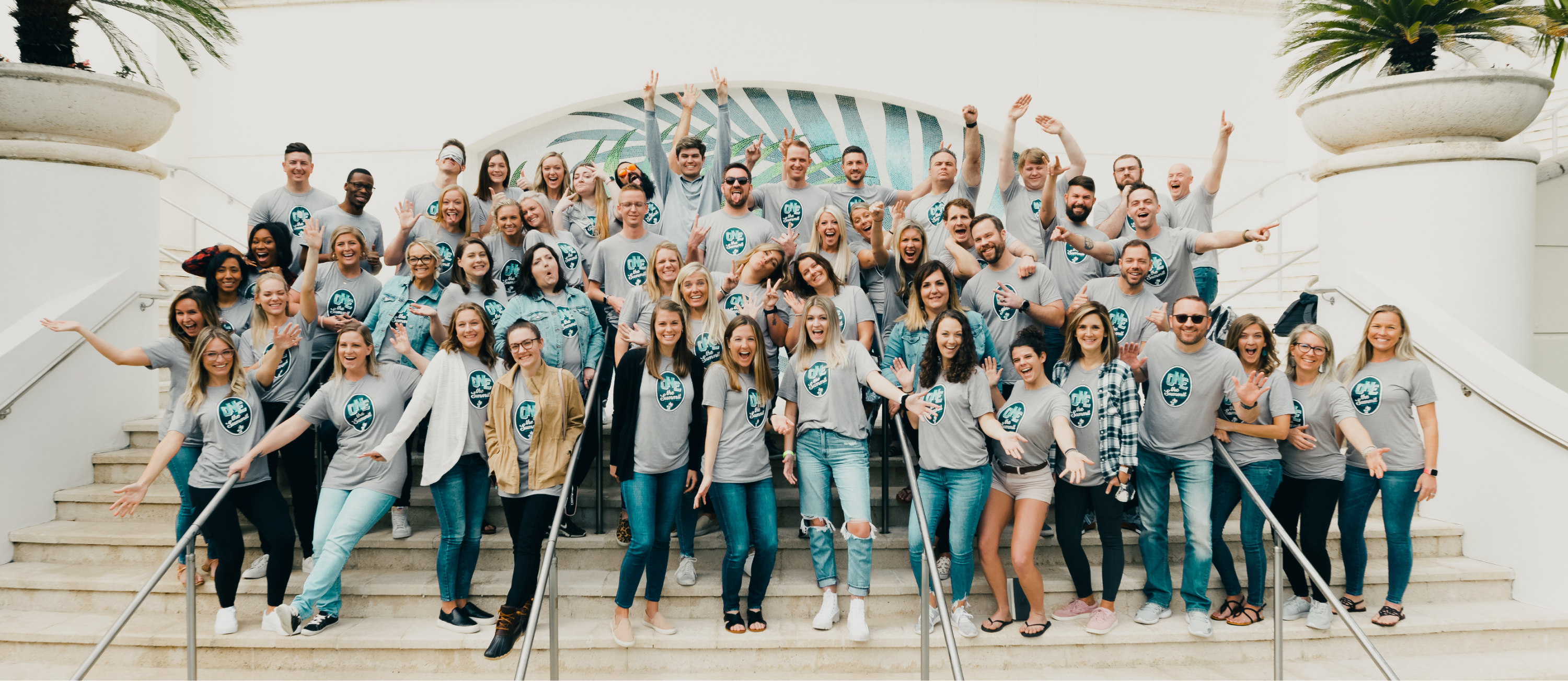 Gravy team members gathered on steps in matching company shirts