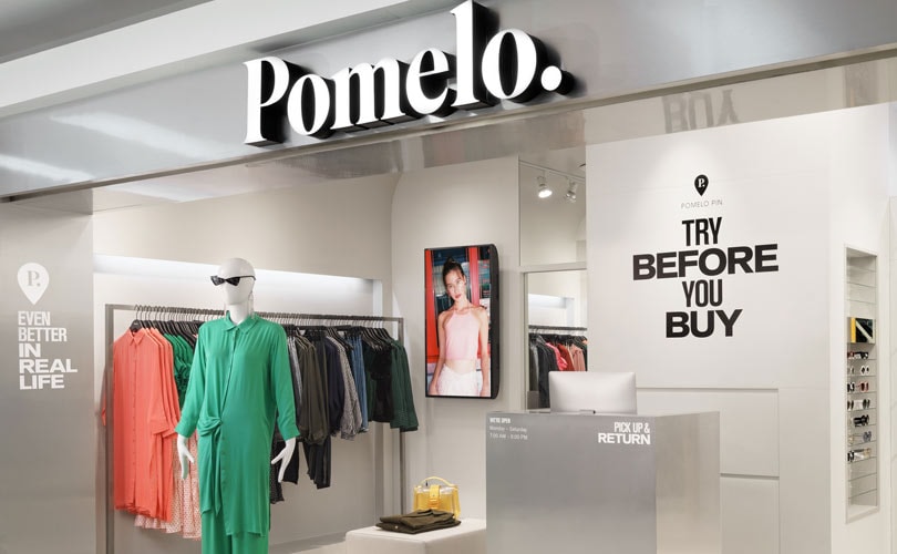 A Pomelo store with clothing rails and a try-before-you-buy sign