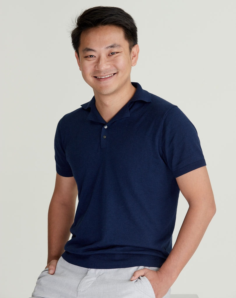 Casey Liang in a navy polo shirt in a Pomelo press photograph