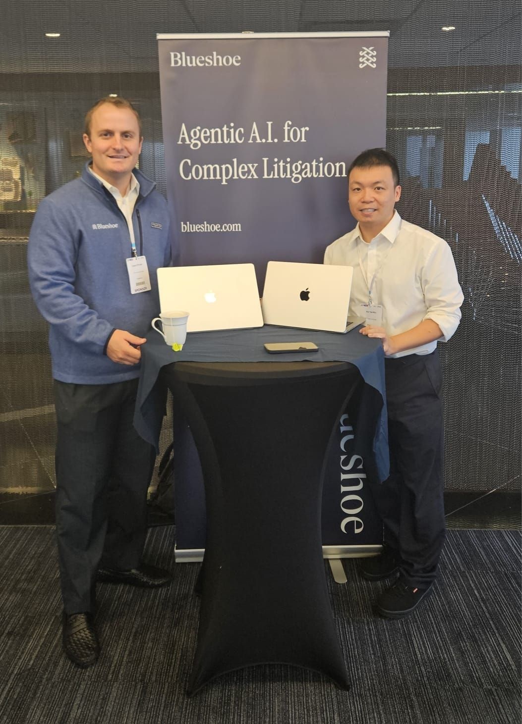 Casey O’Grady, left, and Kai Yee Wan beside their Blueshoe banner at Future Lawyer USA