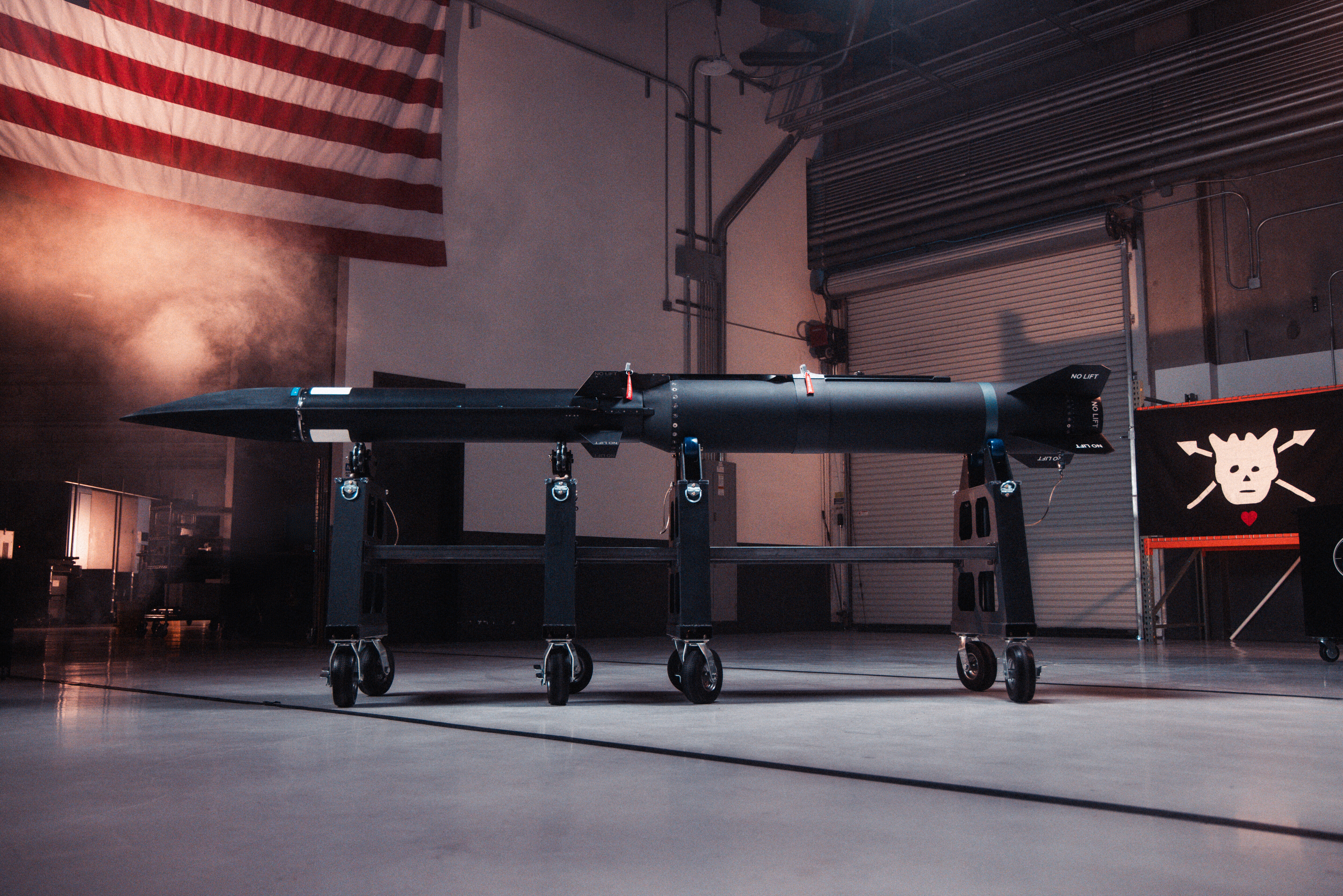 Blackbeard missile on wheeled stands inside Castelion’s facility, beside a pirate-style flag