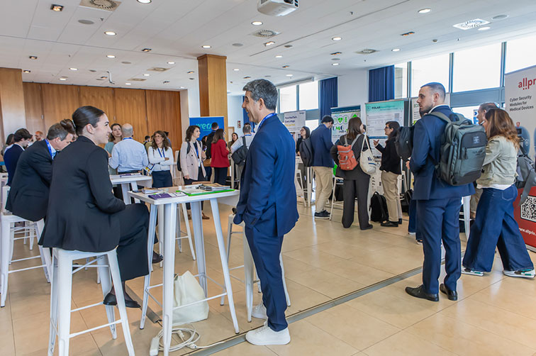 Professionals talking around high tables and exhibition displays at Connection Day 2026