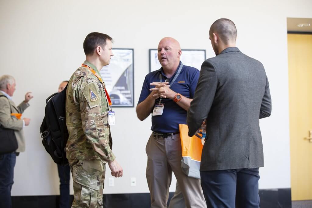 Military and civilian attendees talking at a Catalyst Campus gathering