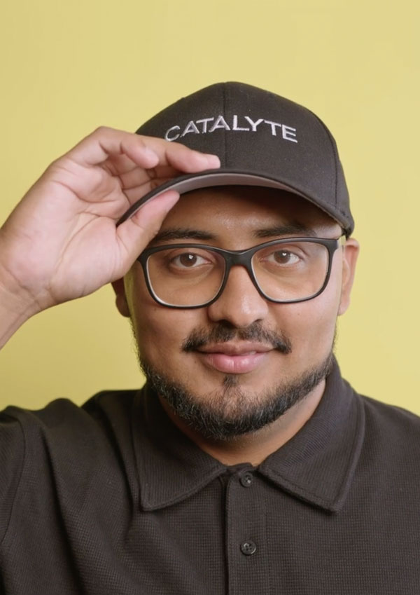 Catalyte software developer Ricky wearing glasses and a baseball cap