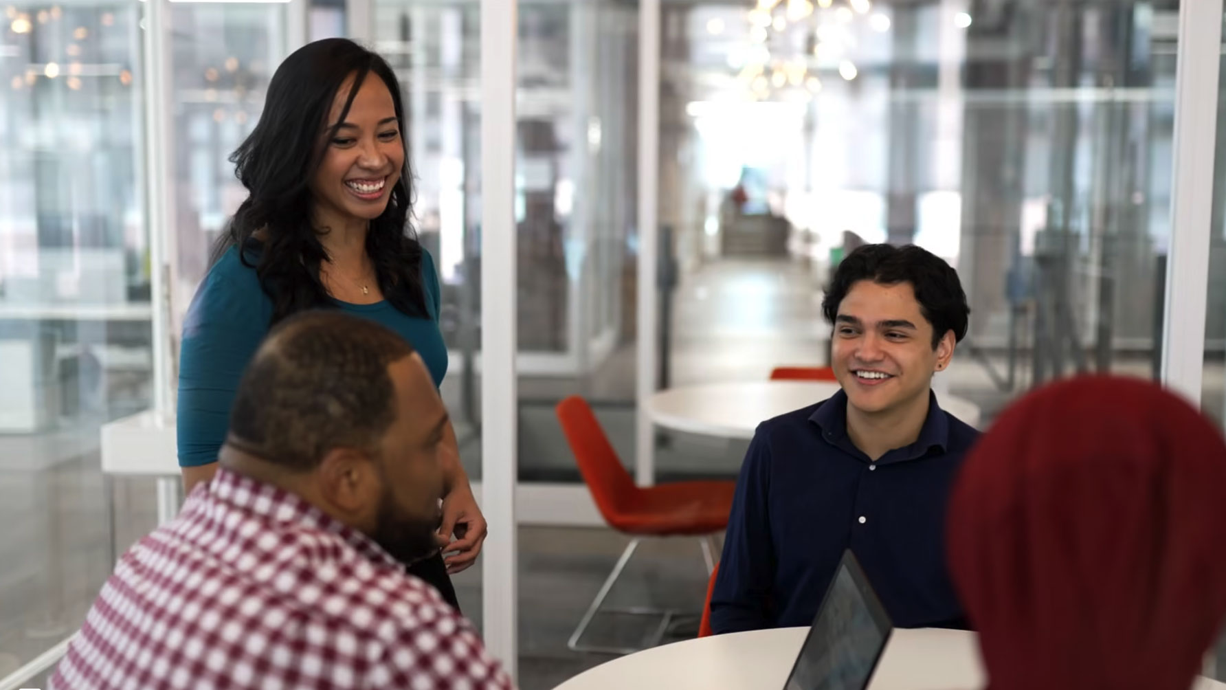 Catalyte apprentices collaborating around a conference table with a laptop