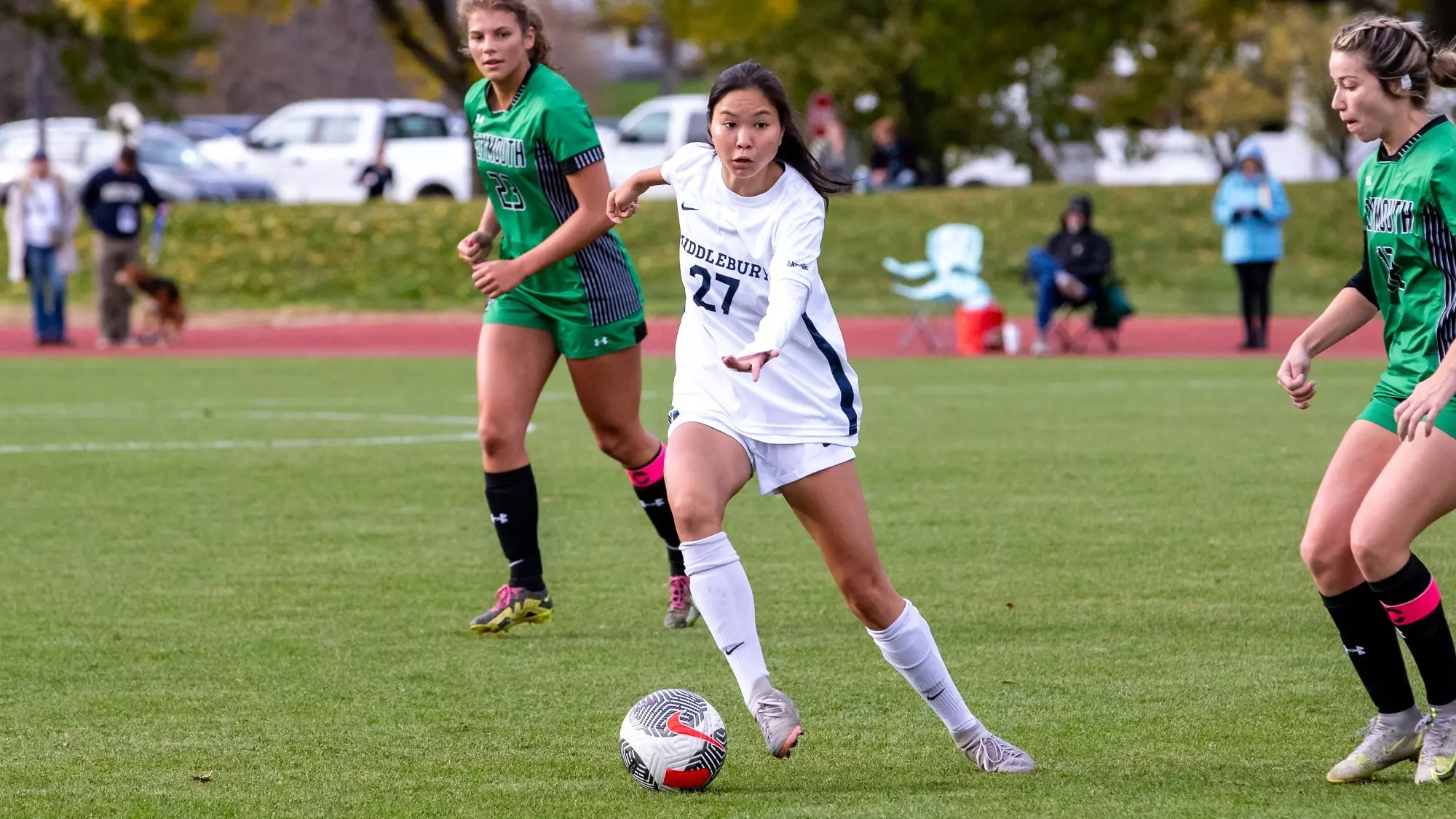 Cate Woolsey, wearing Middlebury number 27, playing against Plymouth State