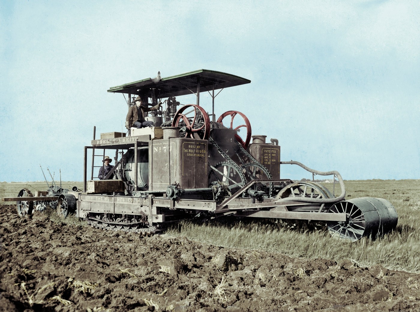 People watch Holt’s track-type tractor prototype No. 77 during a 1904 field test