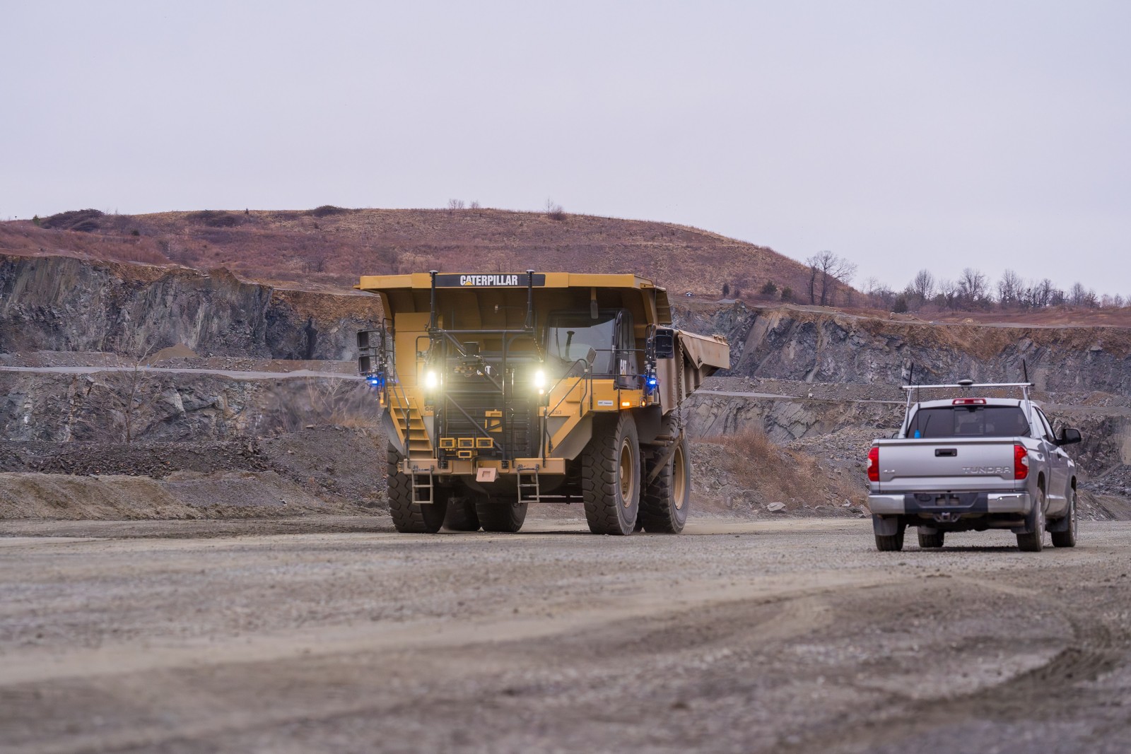 An autonomous Cat haul truck passes a pickup at Luck Stone’s Bull Run quarry