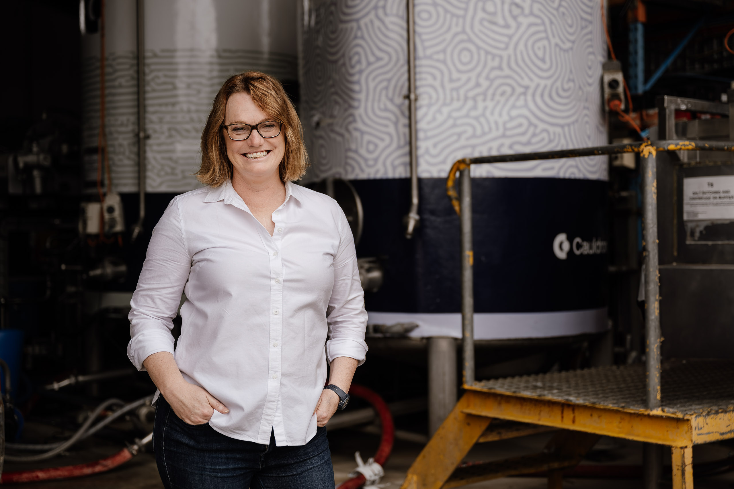 Cauldron co-founder Michele Stansfield standing in front of fermentation tanks
