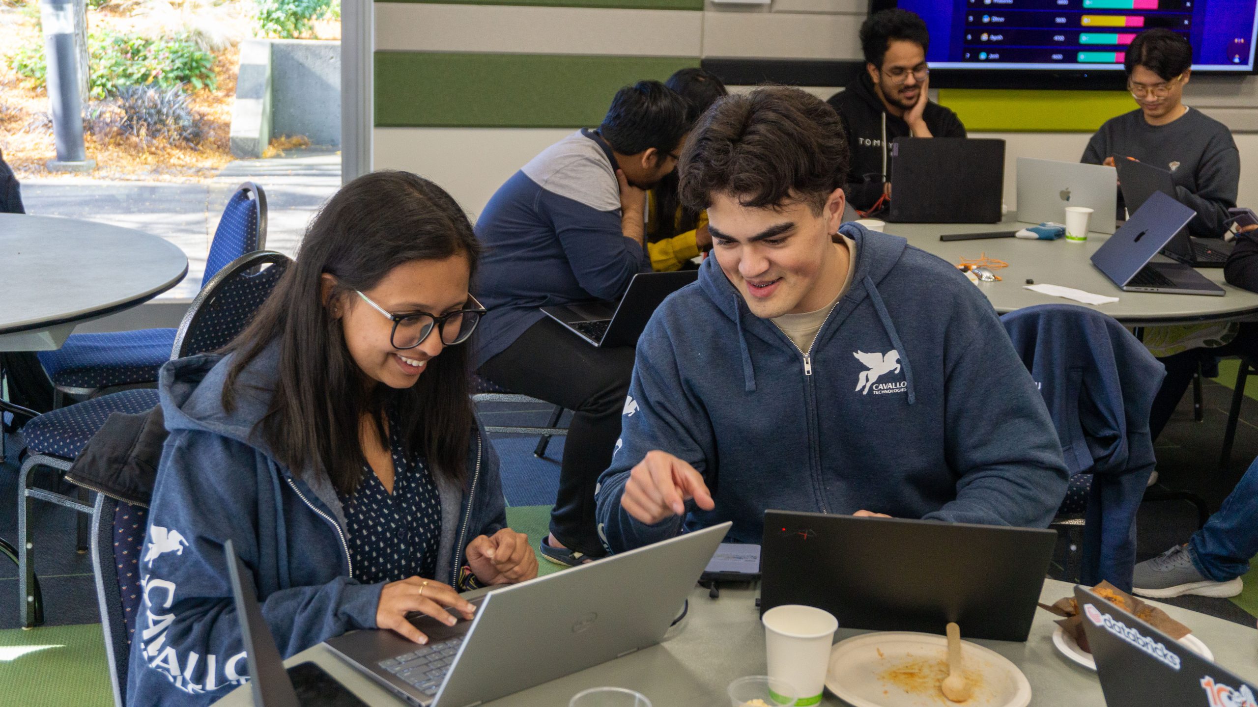 Cavallo Technologies team members collaborating around laptops during a working session