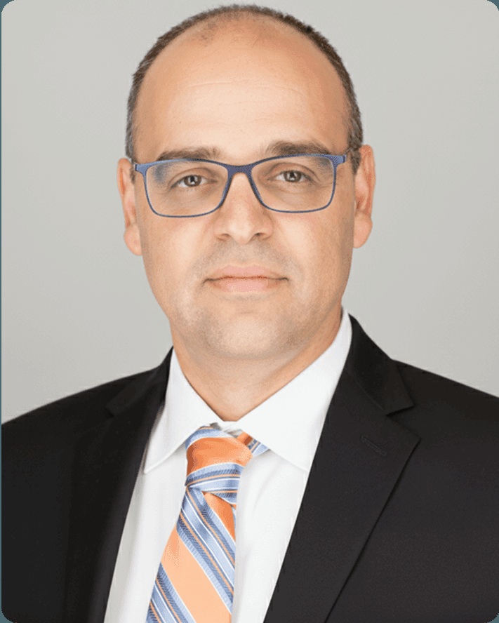 Amir Erez, founder of Cedar Financial, wearing glasses and a striped tie