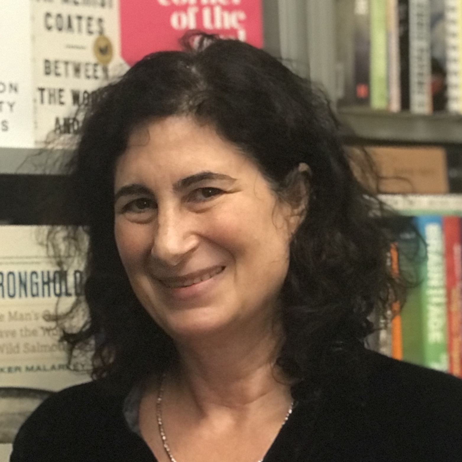 Celina 'Cindy' Spiegel in front of a wall of books