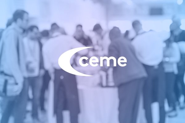 People networking at a CEME event, seen behind a CEME logo treatment