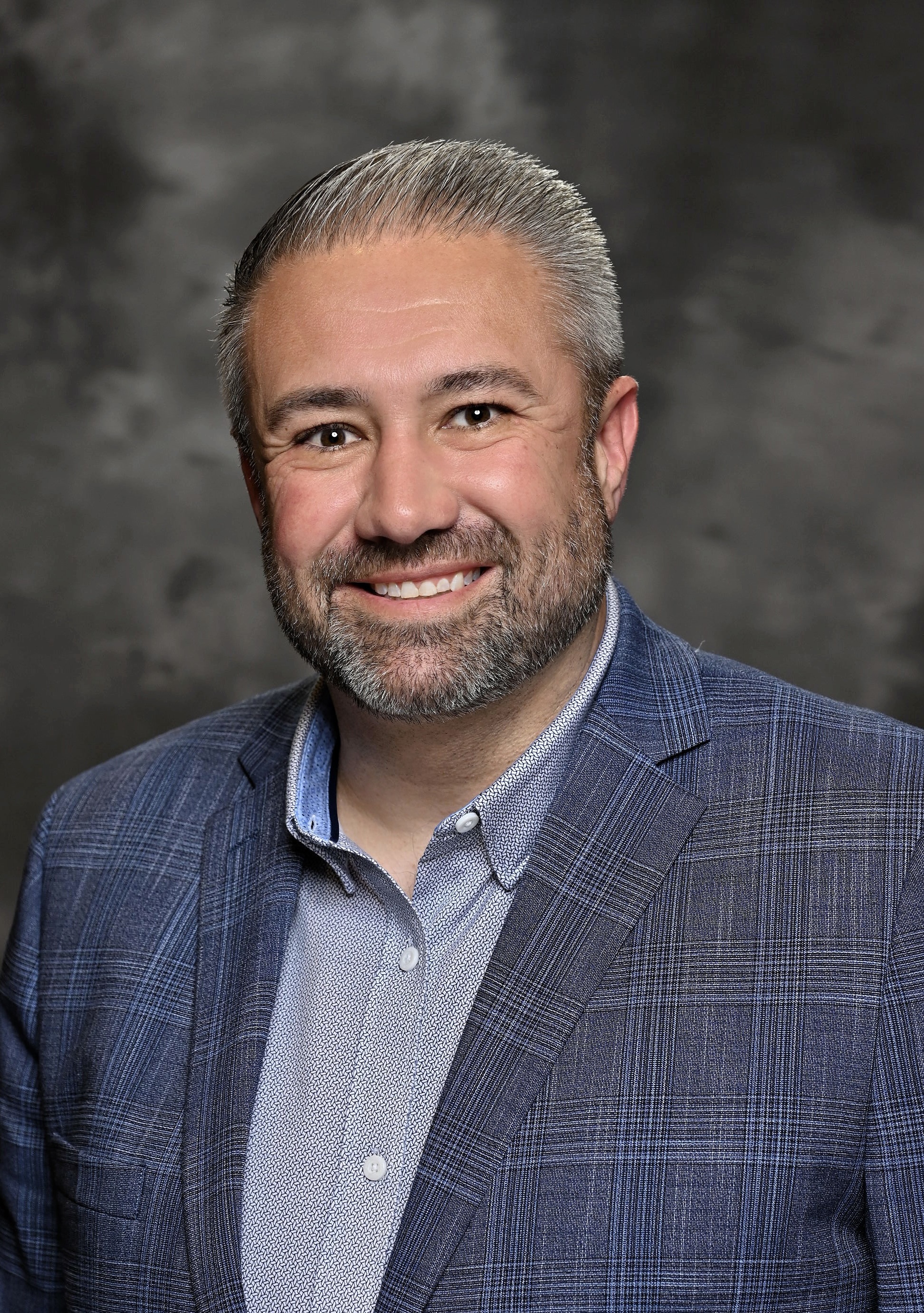 Portrait of Cendyn CEO Michael Bennett in a blue checked jacket