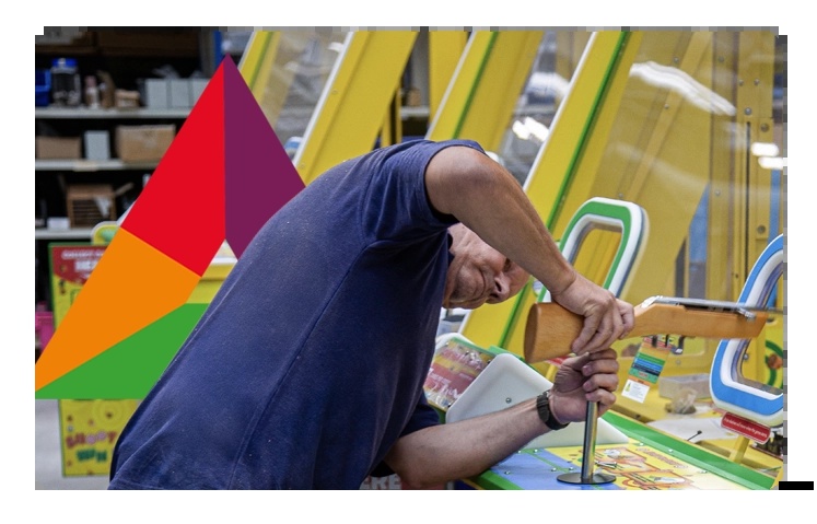 An engineer works with a screwdriver on brightly coloured equipment in Centerprise’s published workshop photograph