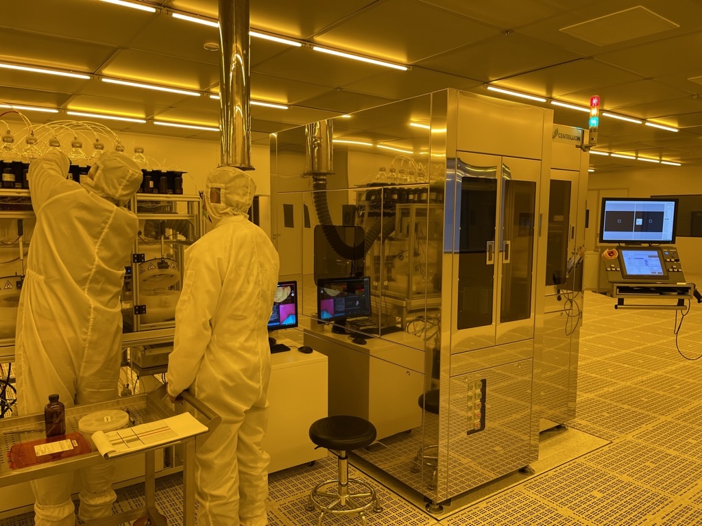 Centrillion technicians and automated lithography equipment in a cleanroom