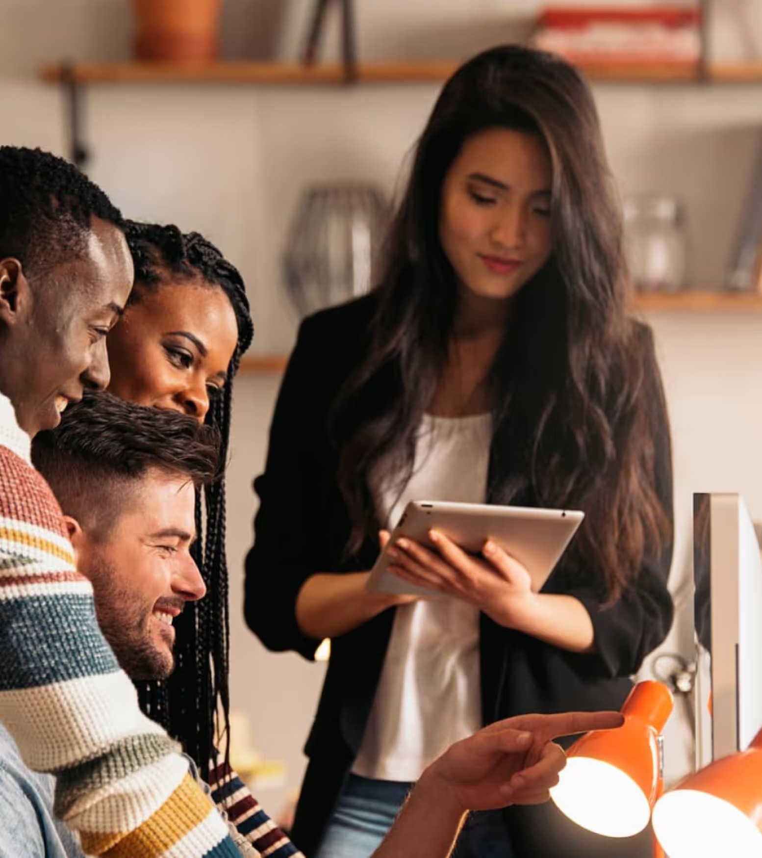 People collaborating around a tablet and computer