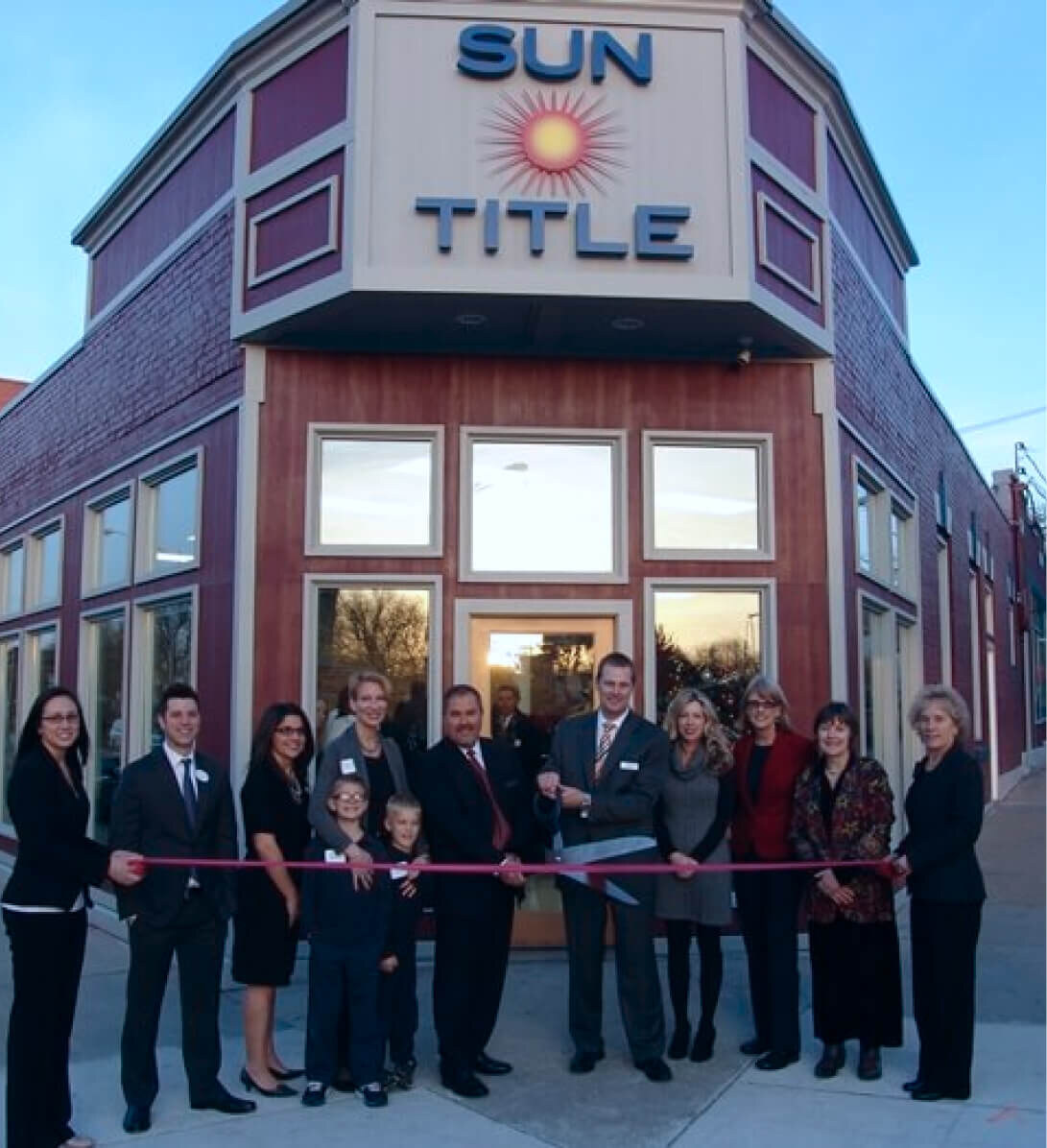 The Sun Title team at a ribbon-cutting ceremony