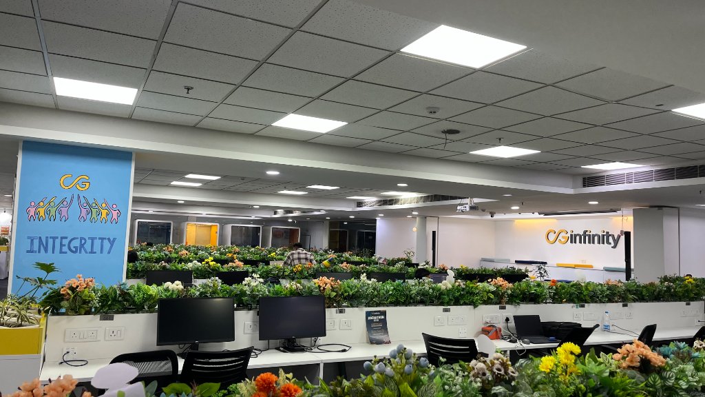 CG Infinity workspace with planted desk dividers and integrity mural