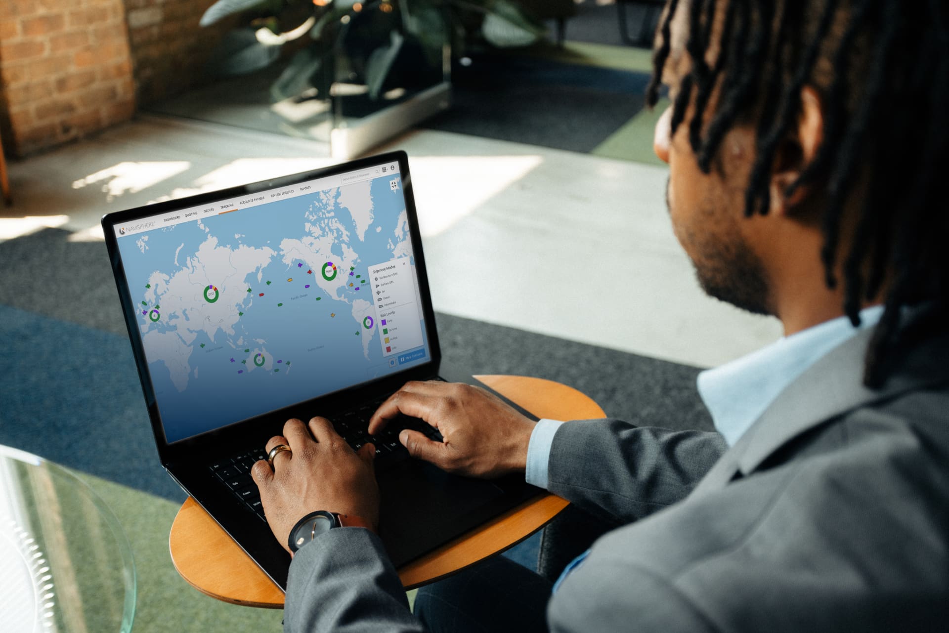 A person using Navisphere’s shipment map on a laptop