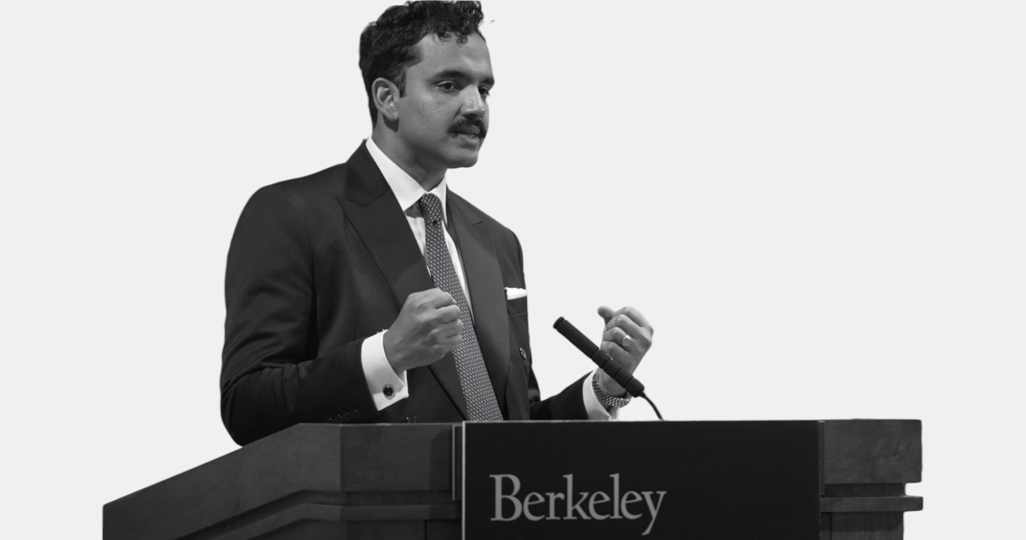 Chai Mishra speaking at a Berkeley lectern during his 2025 graduation address