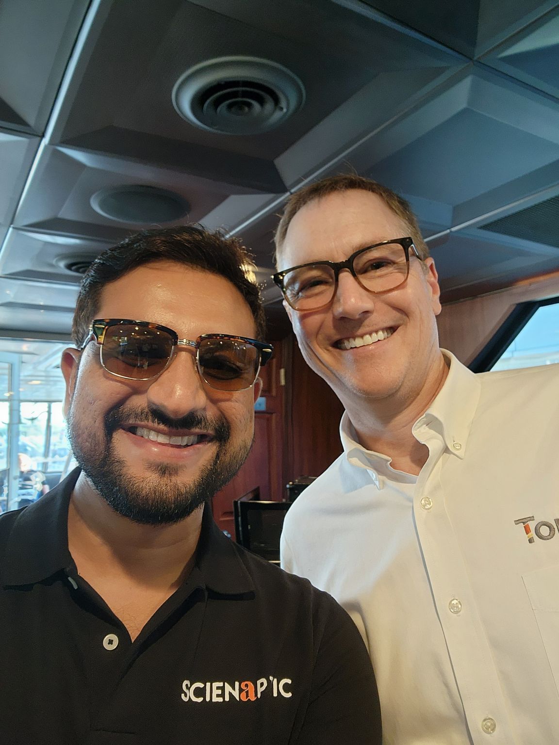 Chandan Pal, left, wearing a Scienaptic shirt and sunglasses with a fellow attendee at the Virginia Credit Union League IGNITE 2024 gathering